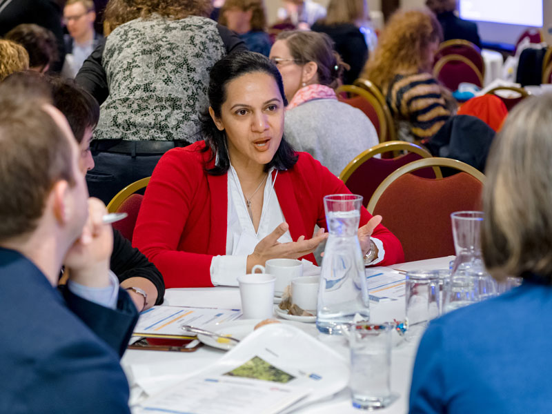 People at a table, deep in discussion