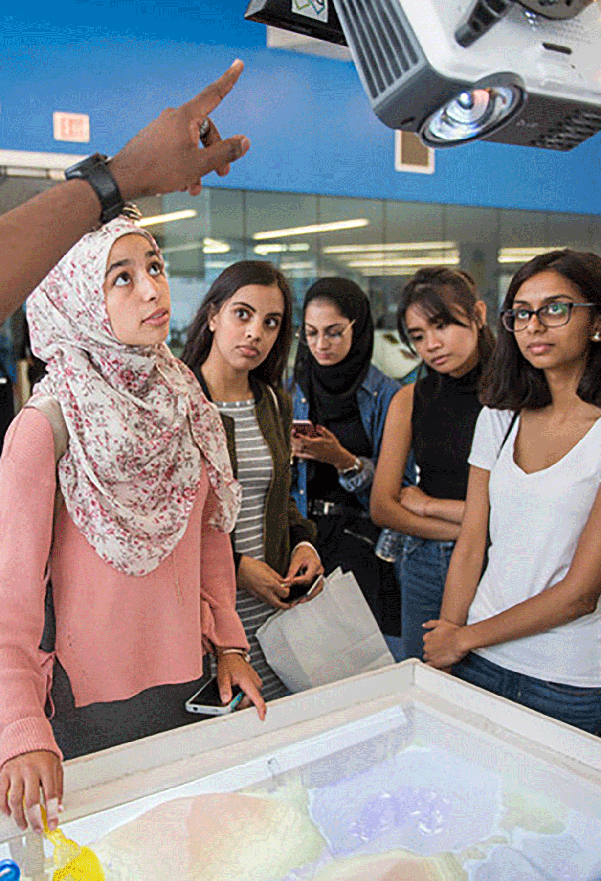 A diverse group of Ryerson students are being instructed on how to use classroom technology,