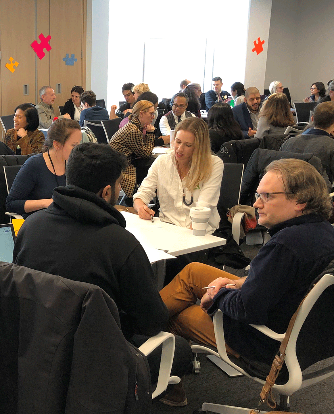 Ryerson faculty and staff are sitting in tables during discussion groups as part of the experiential learning community of practice.
