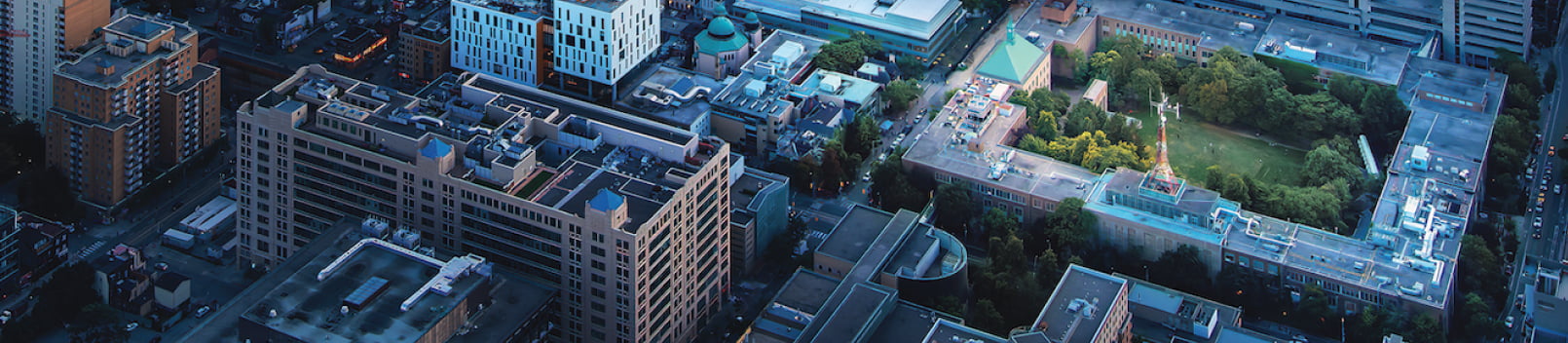 Aerial view of the TMU campus showing Kerr Hall surrounding the green campus quad from above.