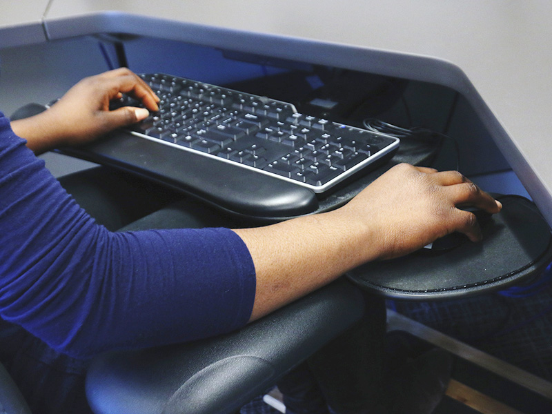 Hands on a computer keyboard.