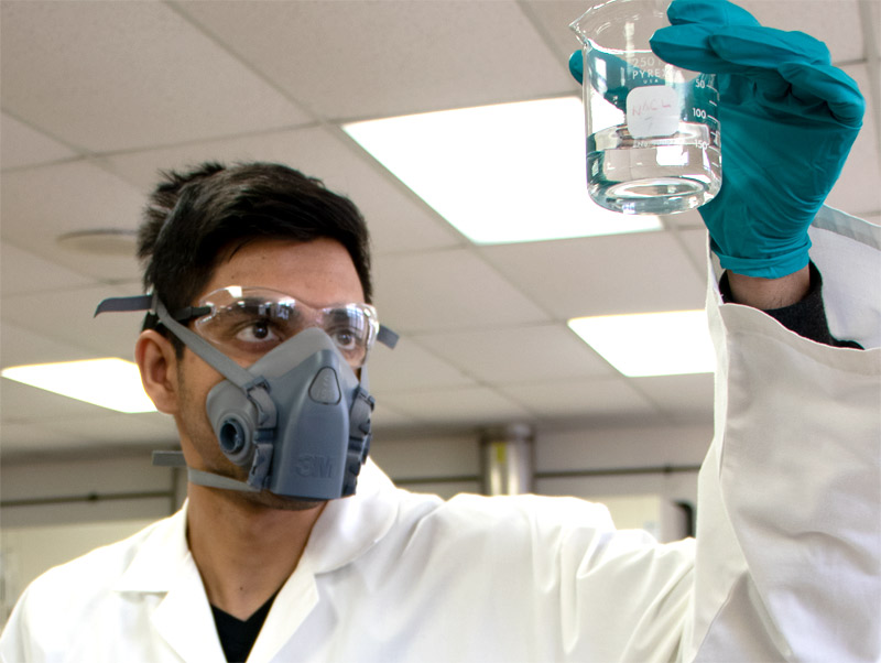 Wearing PPE in a laboratory when working with hazardous chemicals.