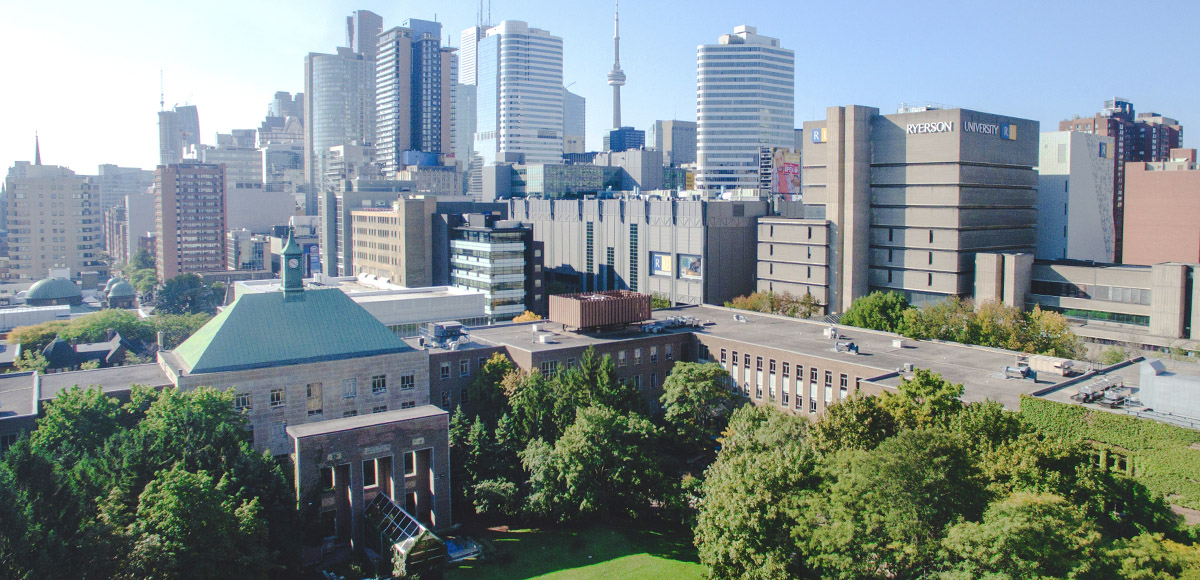 Grassy Kerr Hall Quad with Toronto urbanscape in background.