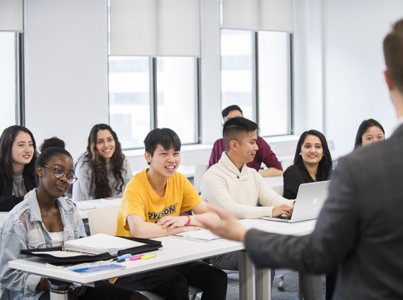 A diverse group of students in class listening to the lecturer.