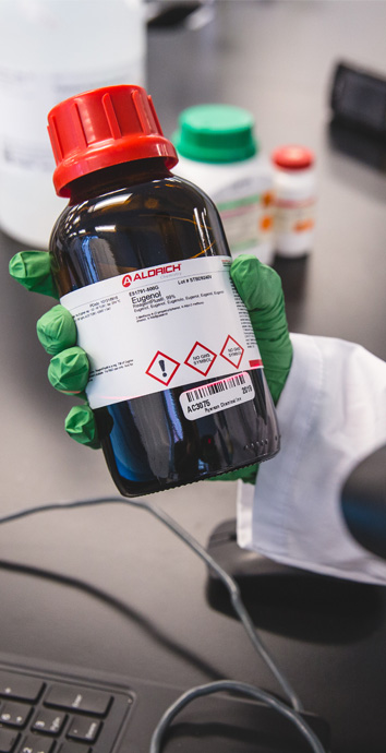 Close-up of a scanner capturing the barcode on a chemical label.