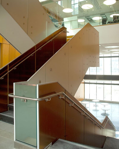 A convenience staircase is open to the larger interior space and terminates within the building, in an atrium, corridor or main space.