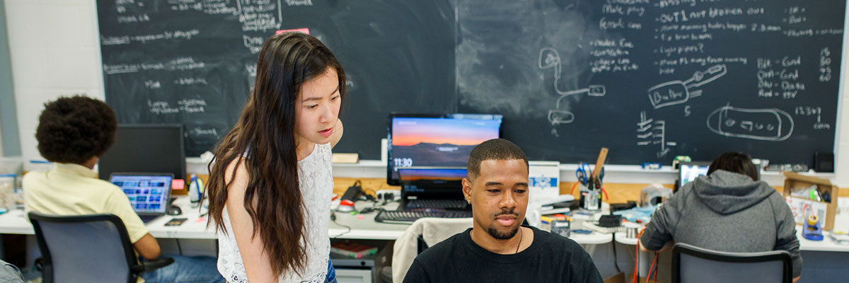 Two students collaborating in a classroom.