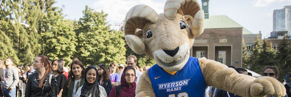Ryerson mascot and a group of people at the orientation