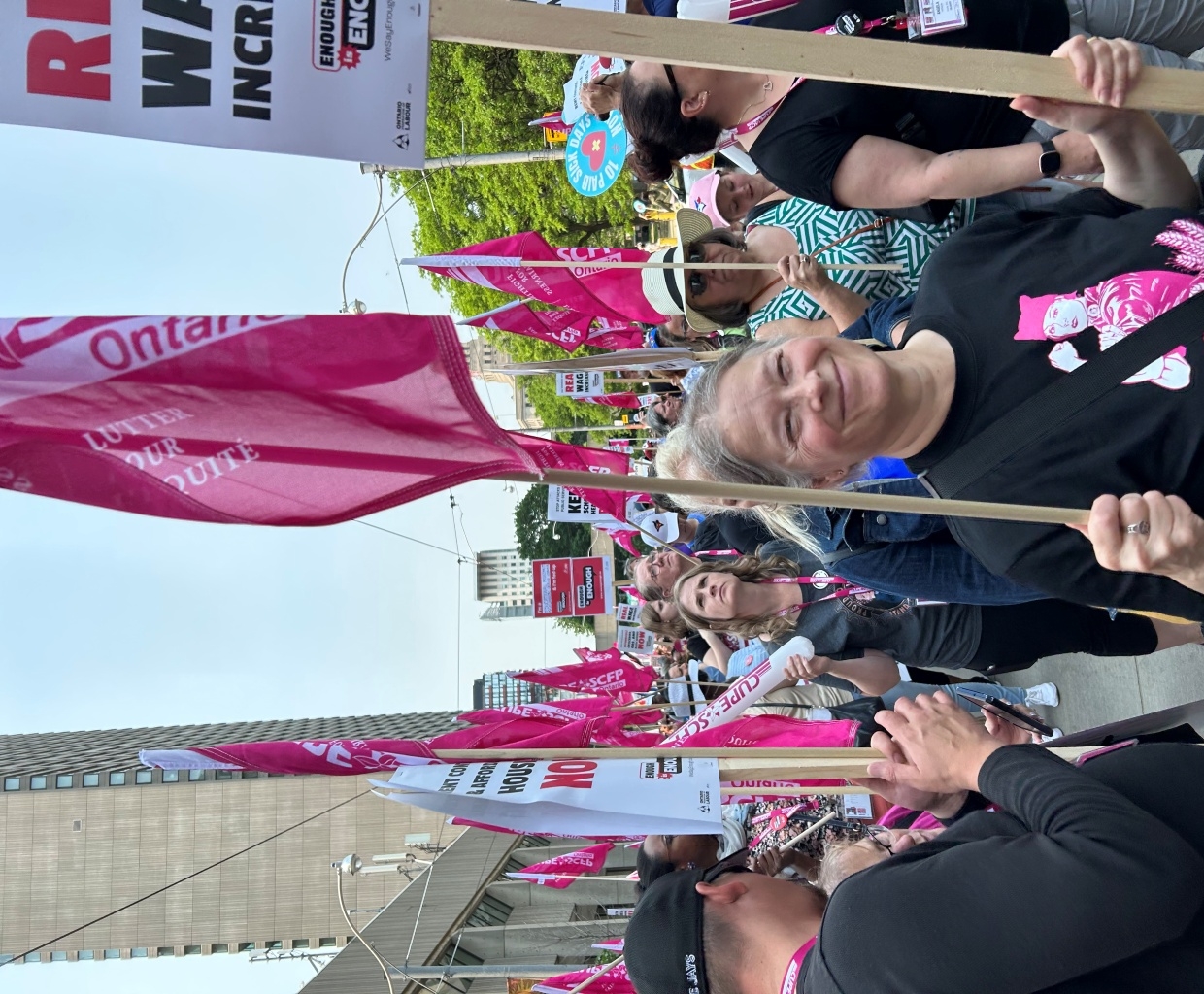 Catherine Jenkins at the 2025 CUPE rally holding a flag and sign