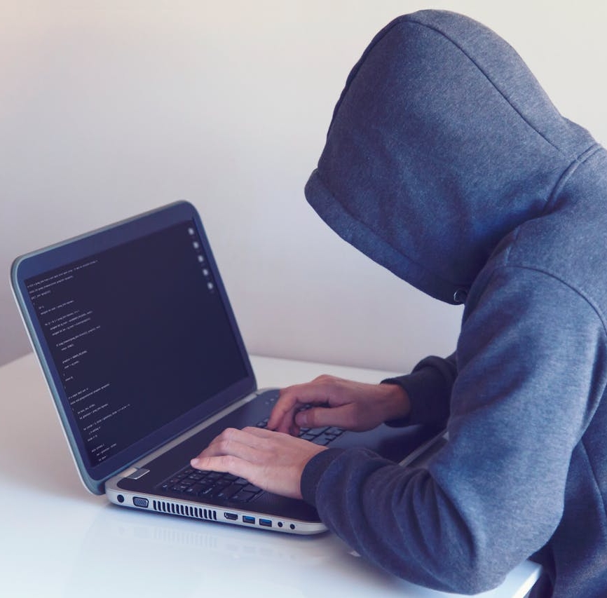 hacker on laptop trying to gather information