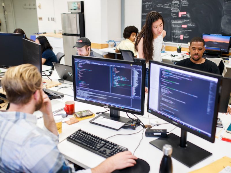 A computer classroom with students working on computers.