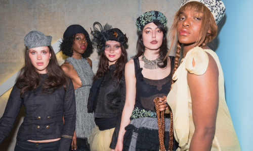 Four models posing during a Mass Exodus fashion show.