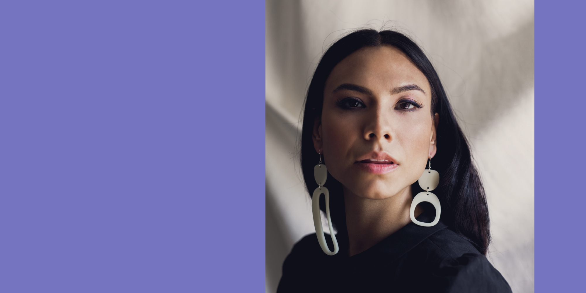 Model wearing contemporary Indigenous designer and alumnus, Warren Steven Scott's teardrop white earrings