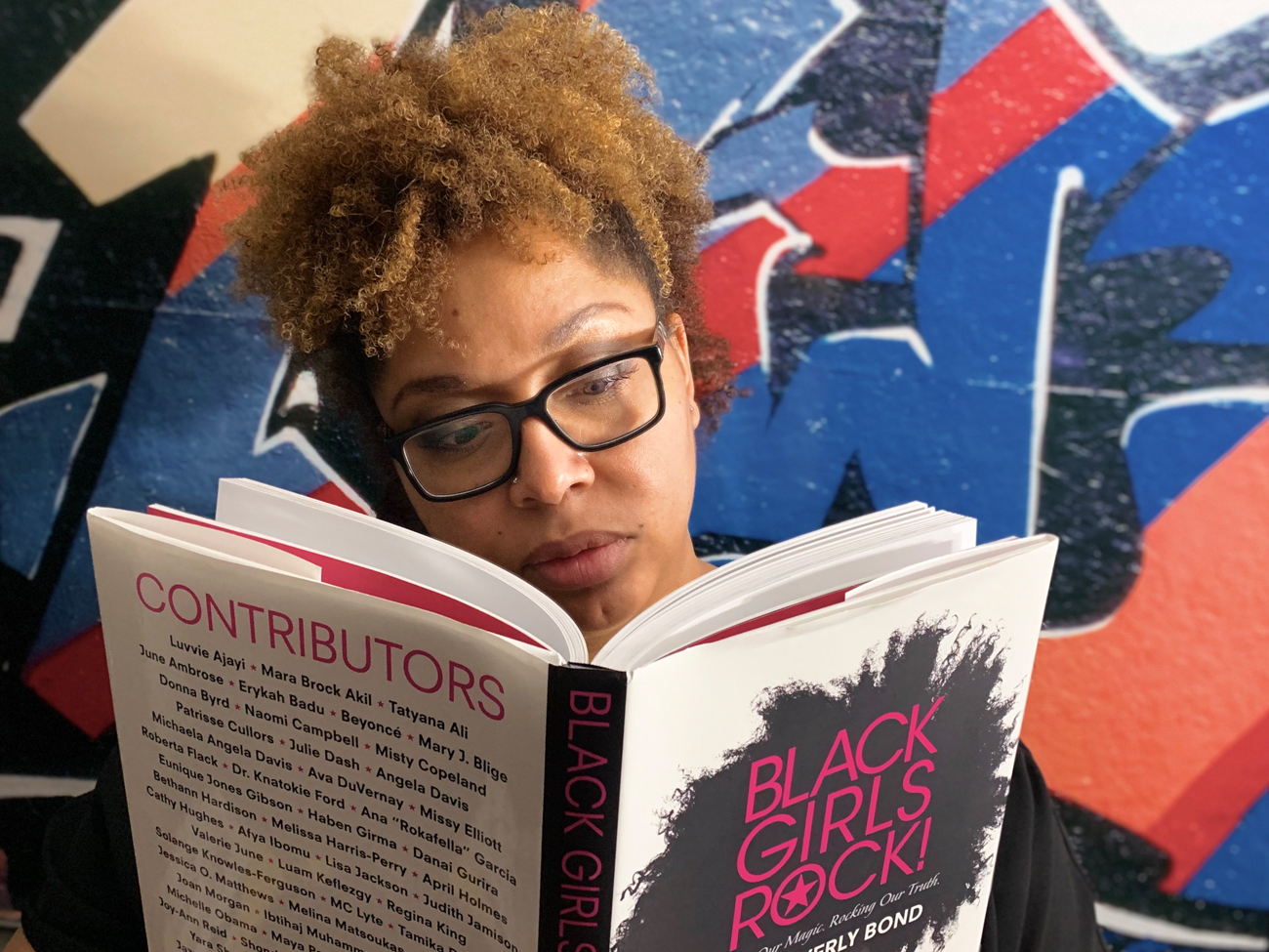 Caron Phinney reading book, "Black Girls Rock!"
