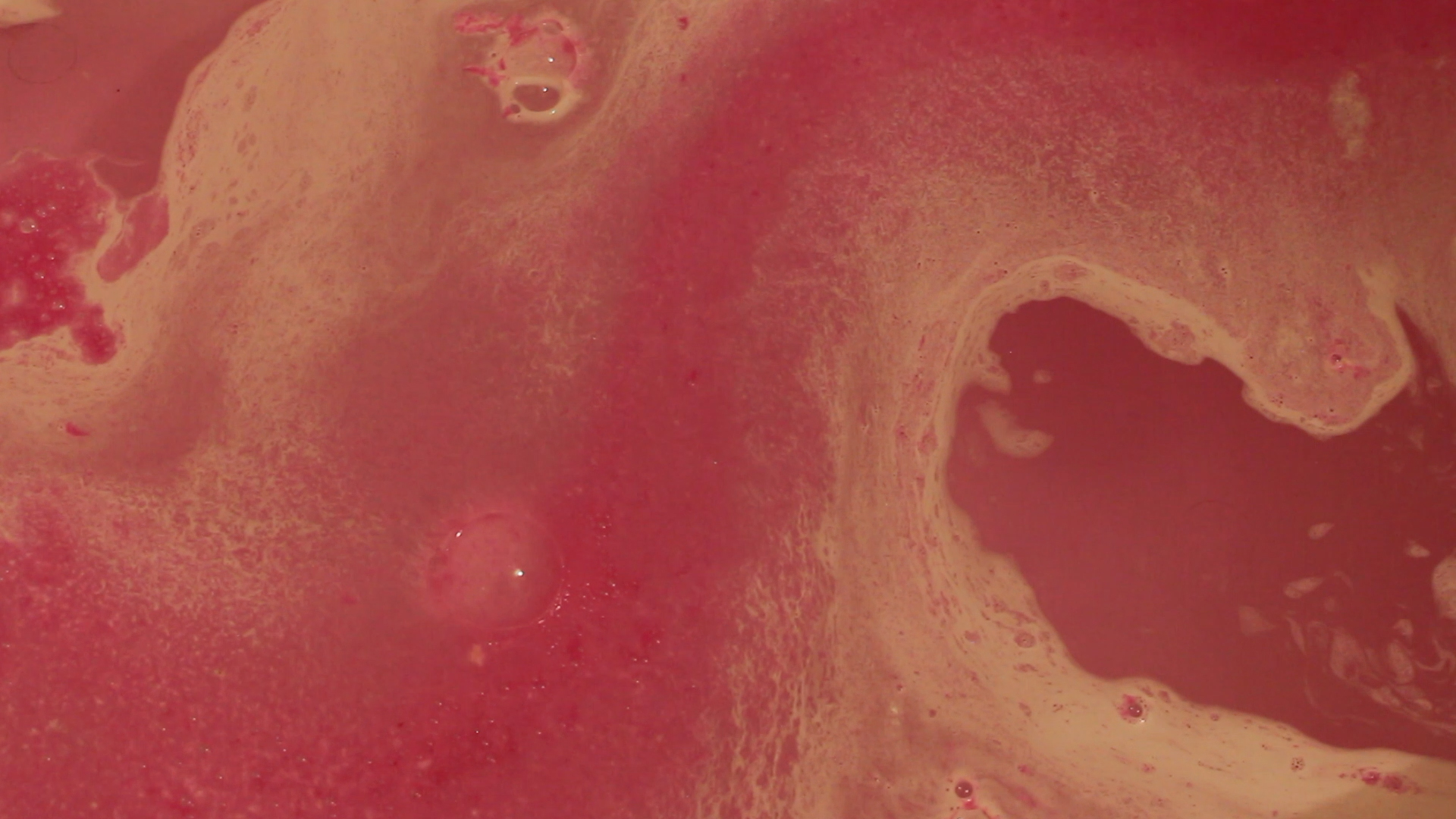 Red fluid bubbles showing the molecular texture of each bubble within the image