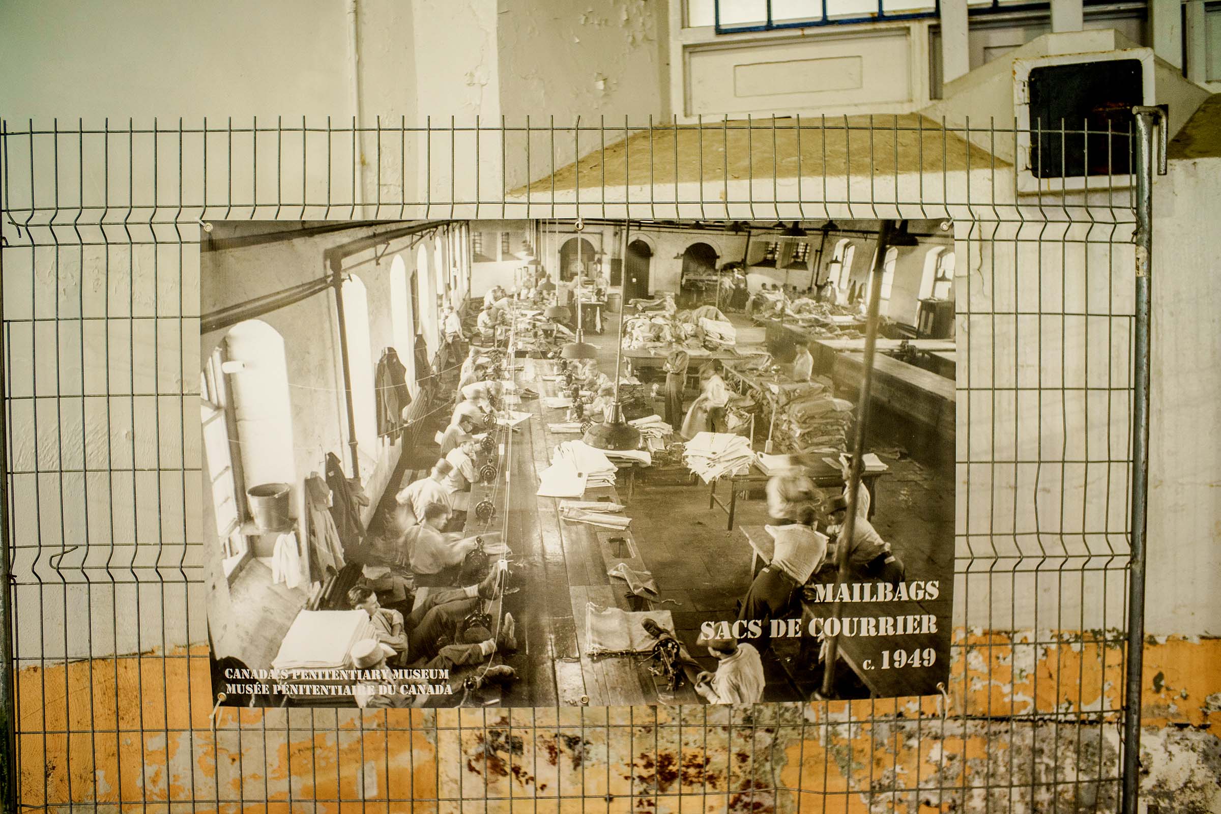 1949 photo of a mailroom from Canada’s Penitentiary Museum mounted on a wire gate