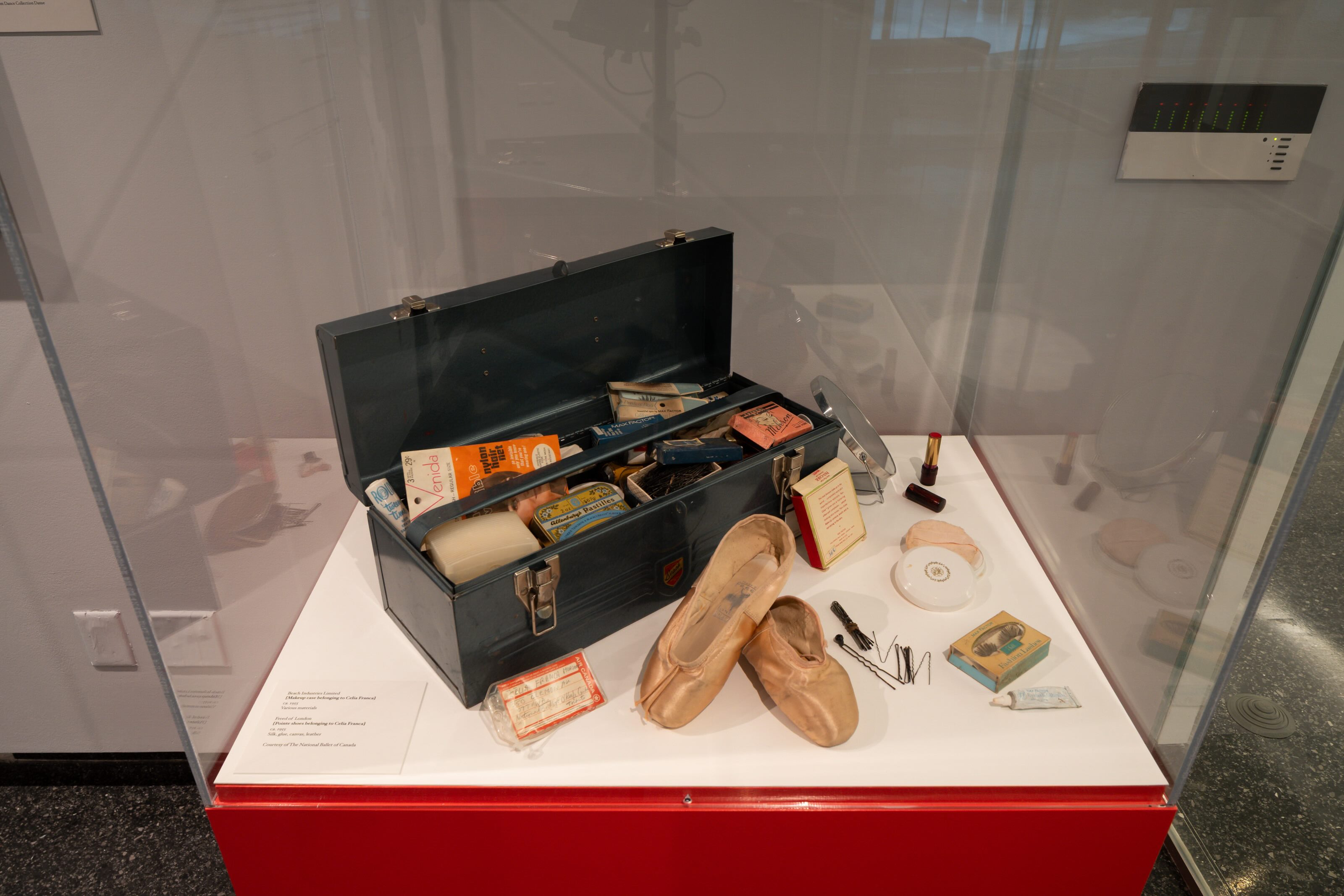 Celia Franca’s make up kit and ephemera shown in a tool box under a glass case. 