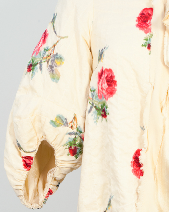 Sleeve of floral bed jacket by Mercy