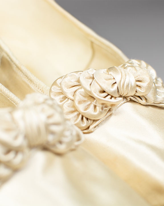 Close up of rosette detail on wedding slippers