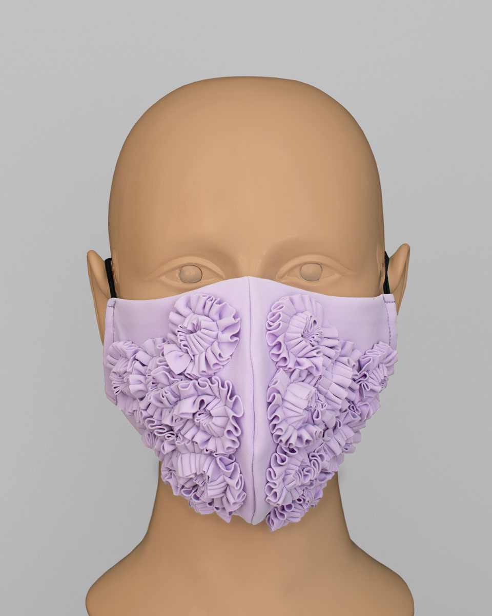Mannequin head wearing a lavender purple face mask with ruffles