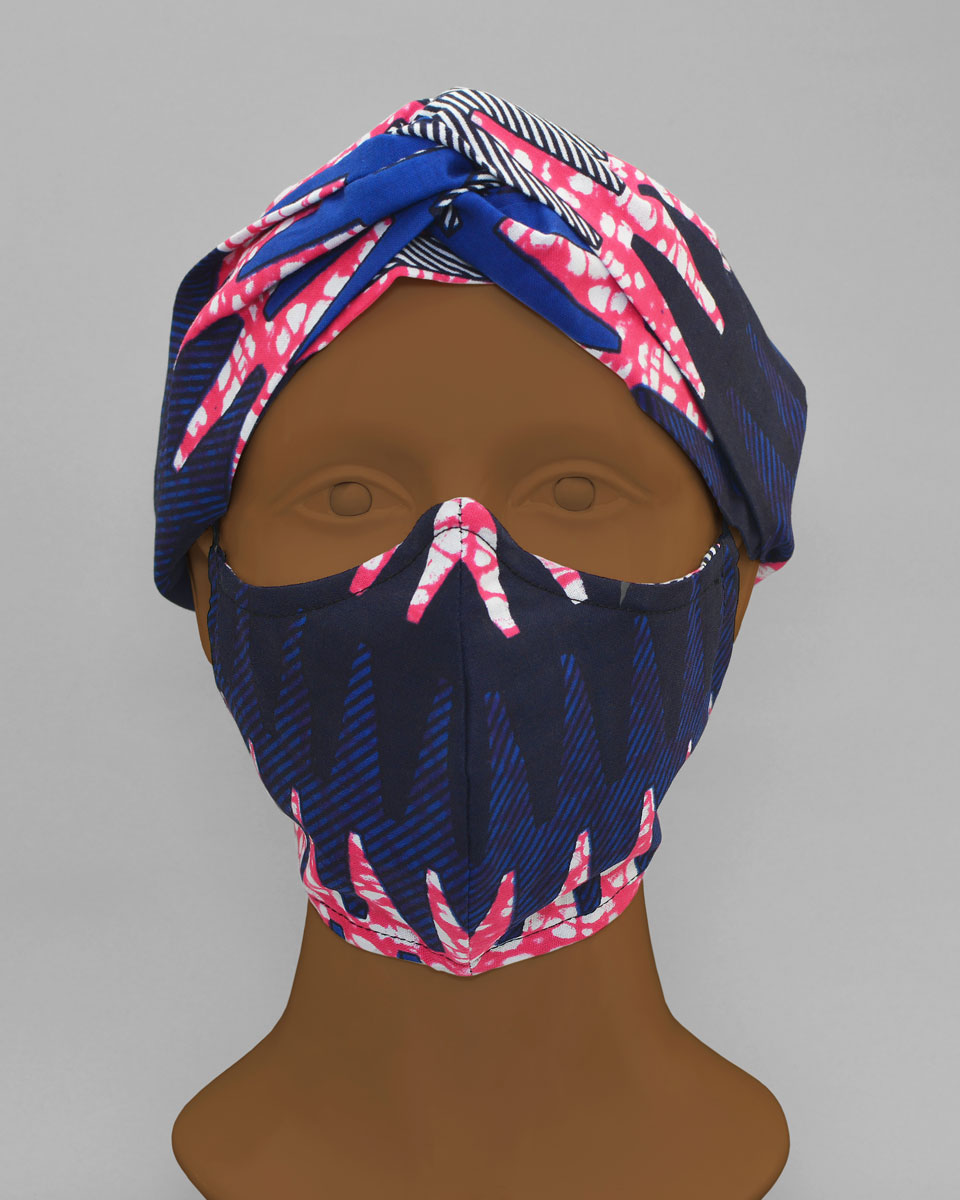 Mannequin head wearing a blue, pink and white patterned head wrap and face mask