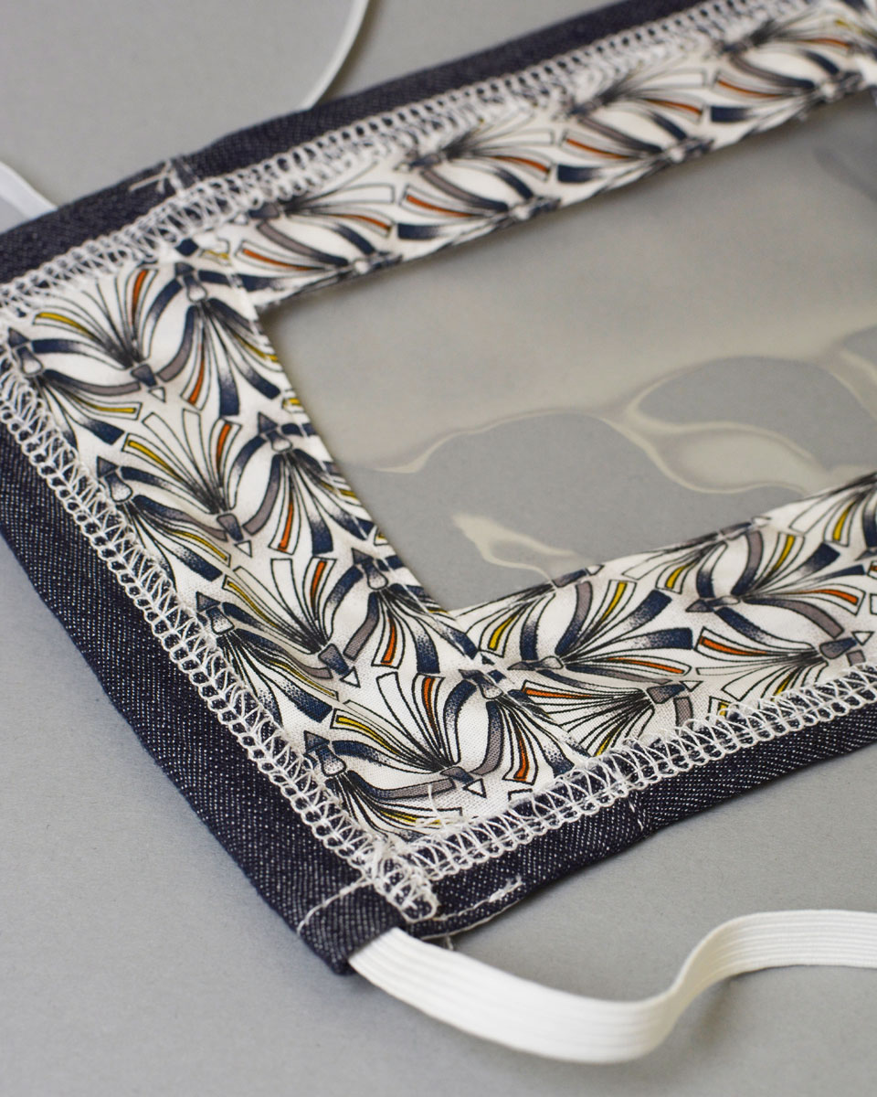 Patterned lining and white head strap on mask