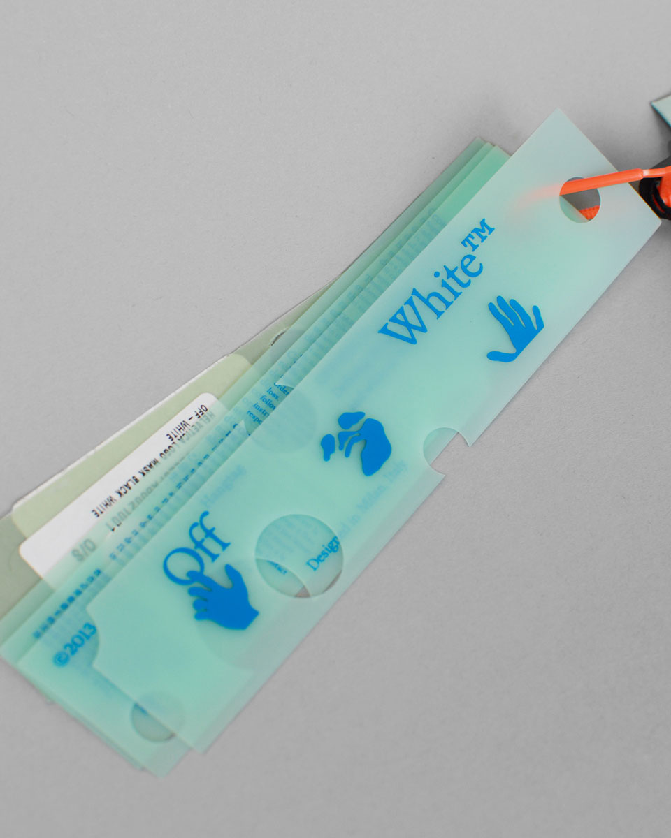 Silicone tags with the Off-White logo and information about the mask