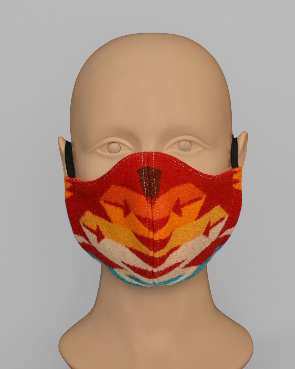 Mannequin head wearing a red sun split shot face mask with an orange, yellow and blue geometric pattern