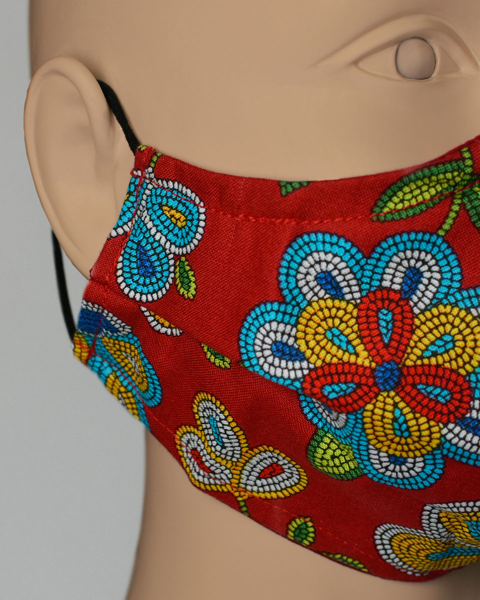 Detail of the pleat on the side of the red floral face mask