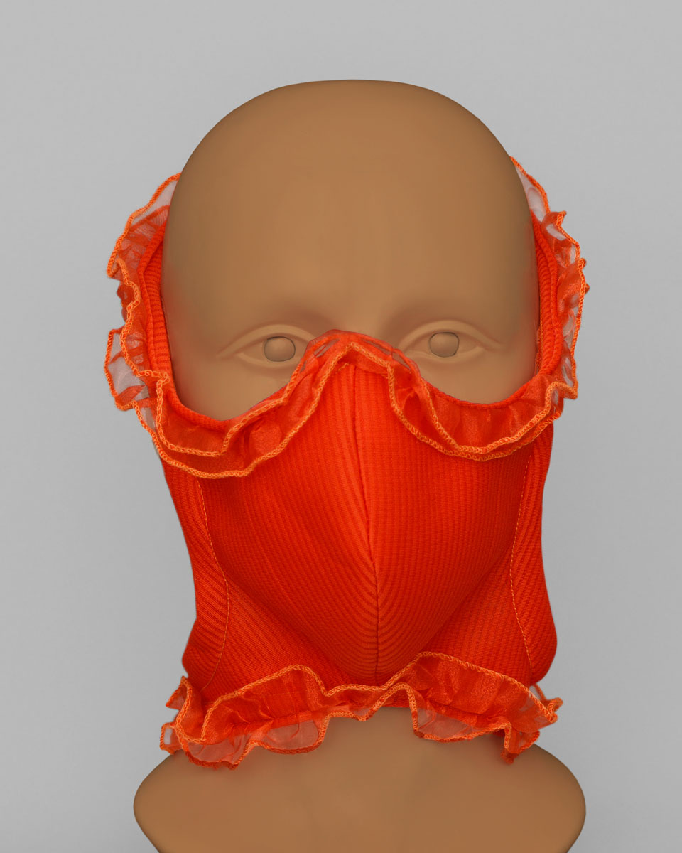 Mannequin head wearing an orange face mask with an orange ruffle trim