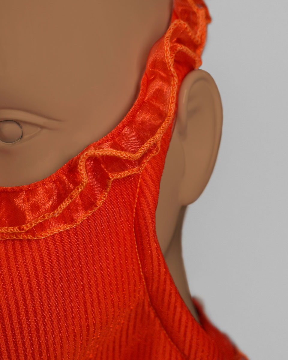 Close up of the ruffled trim on orange face mask