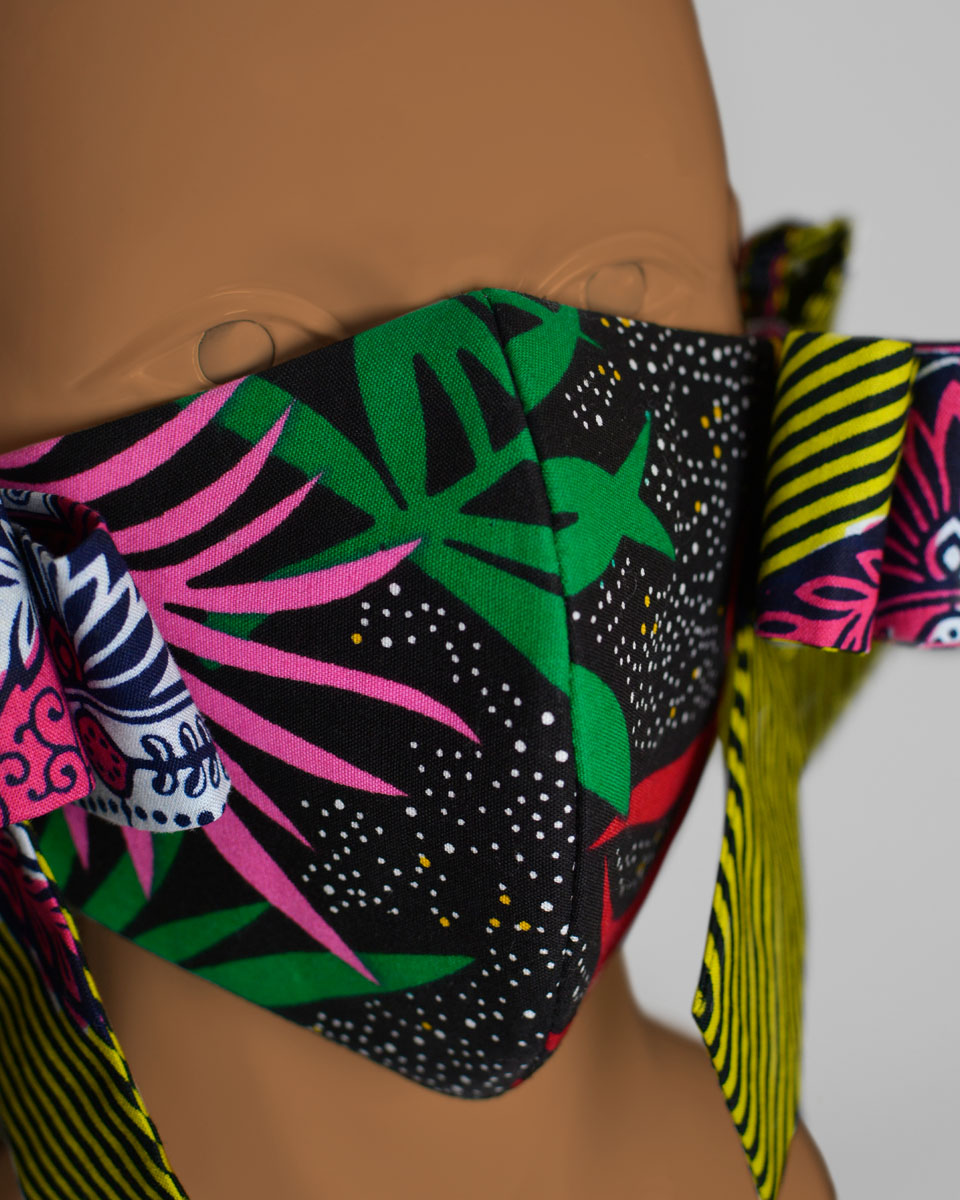 Detail shot of the front of the mask with a colourful floral and striped pattern