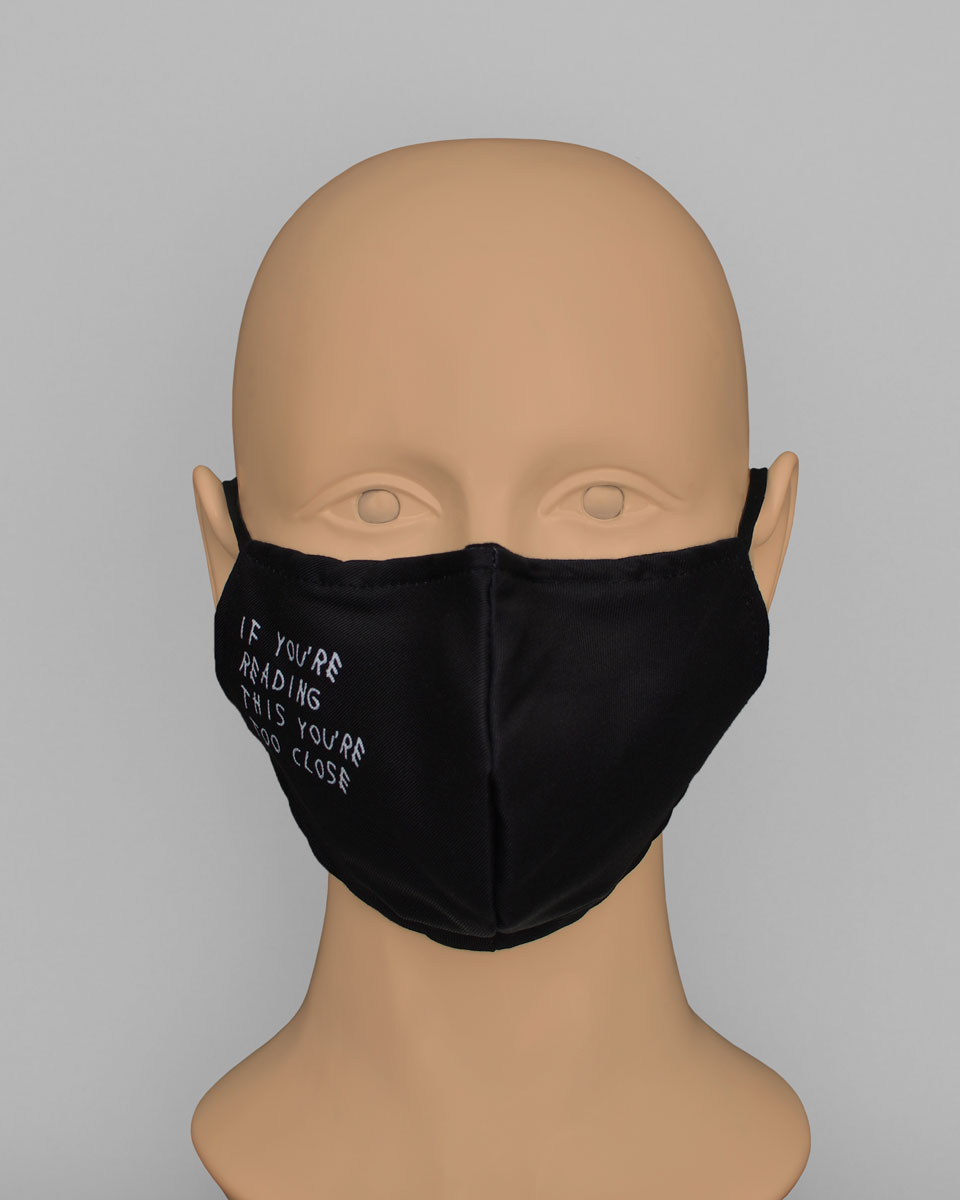 Mannequin head wearing a black mask that reads "if you're reading this you're too close"