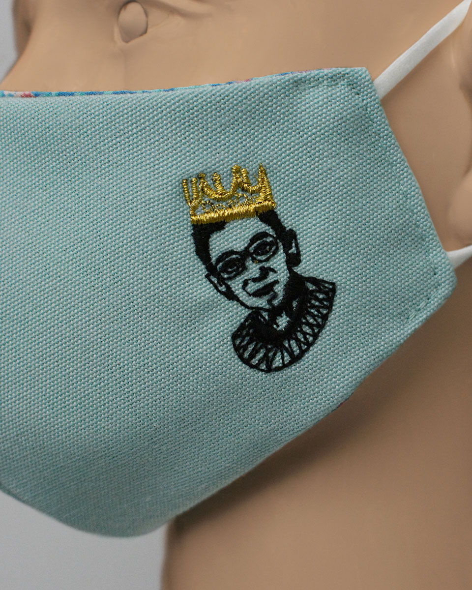 Ruth Bader Ginsburg wearing the Notorious B.I.G. crown embroidered on the side of the mask
