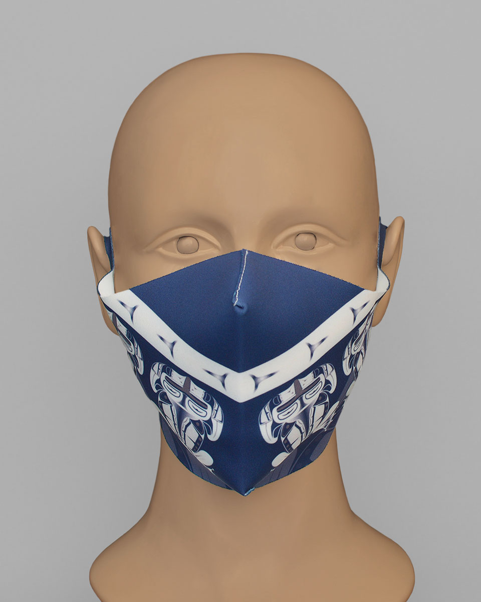 A mannequin head wearing a blue face mask with a white frog print