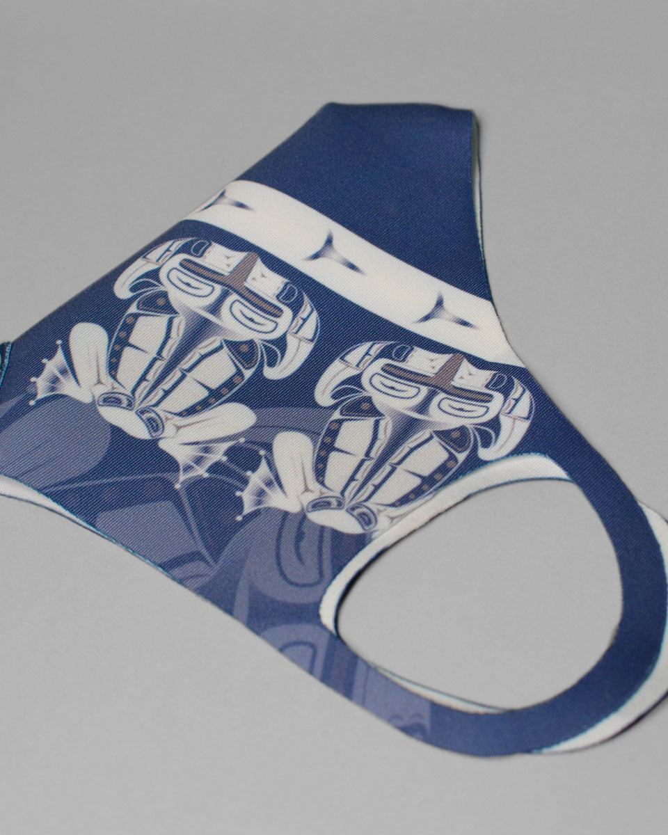 Blue mask with a white Indigenous frog pattern
