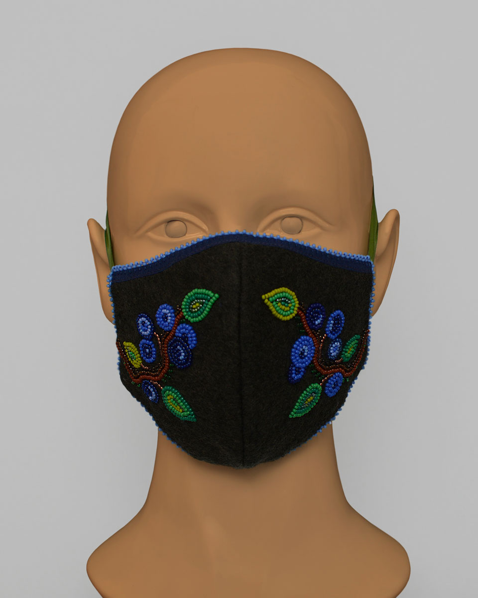 Mannequin head wearing a blue face mask with a beaded blueberry design