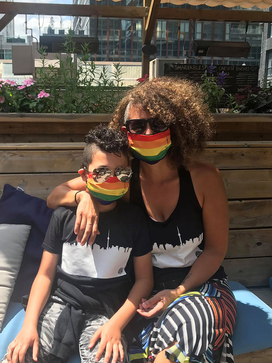 Nadia Lloyd and her son wearing her Toronto Pride mask