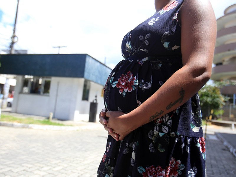 pregnant woman standing outside clinic
