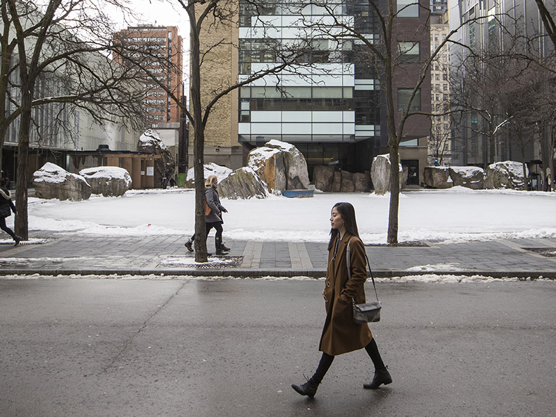 woman walking past Lake Devo in the winter