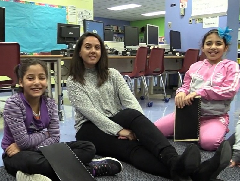 A research assistant with two children from Syria