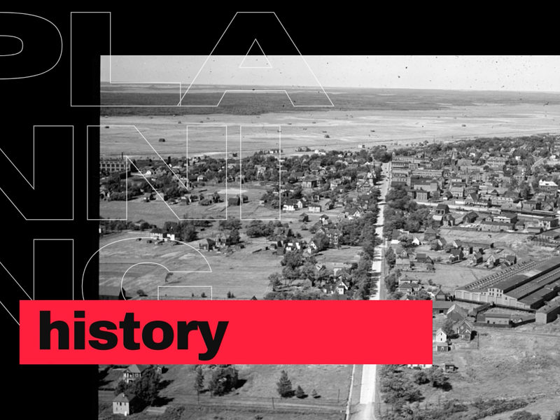 Black and white aerial photo of suburb with white and red overlay text which reads 'planning history'