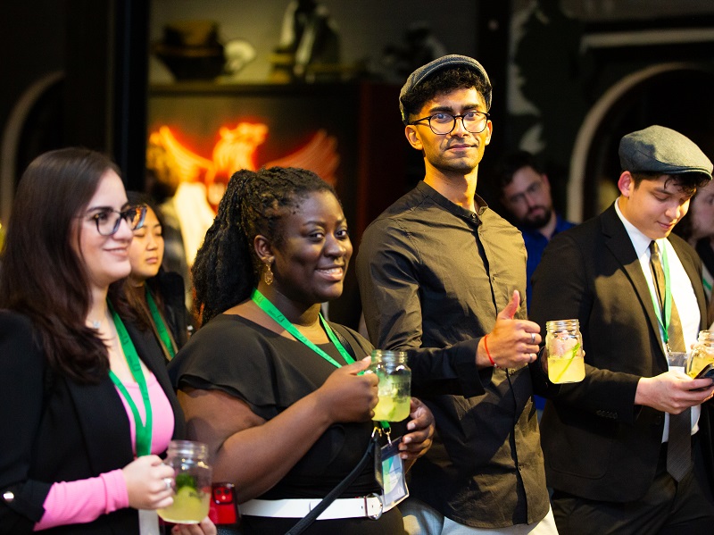 Nicole Agyenim-Boateng and fellow students stand together, holding beverages