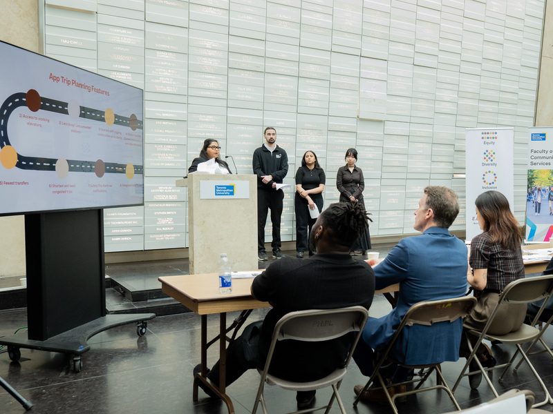 A four-sudent team presents on stage.