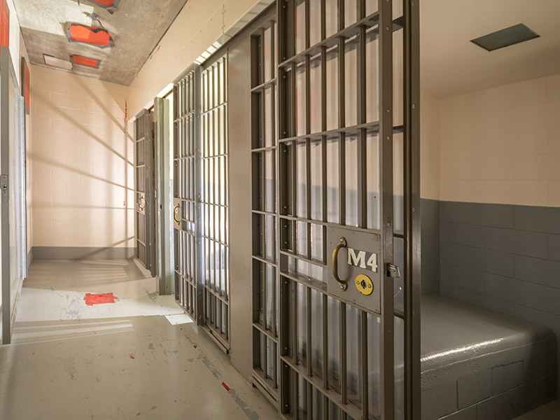 Empty jail cell with the door open