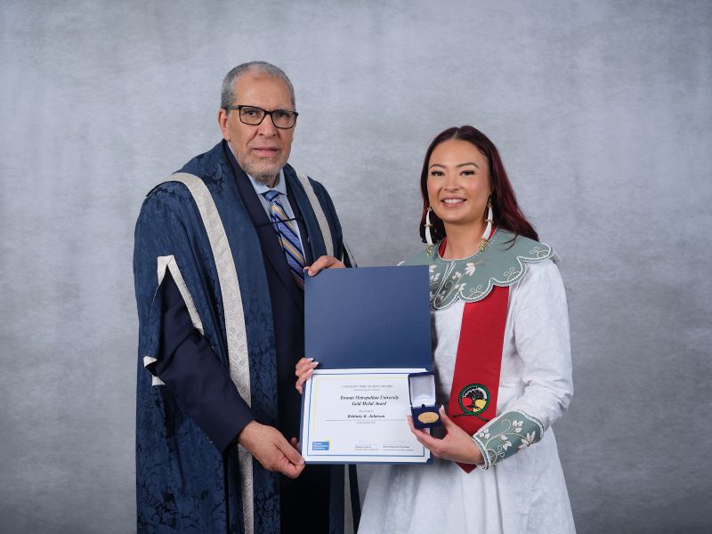 Brittany Johnson receives a TMU Gold Medal from President Lachemi
