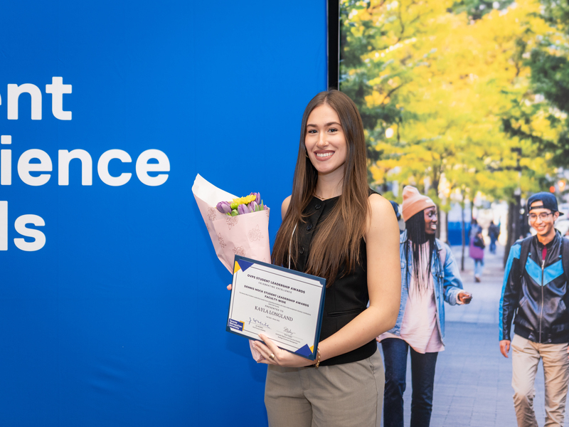 Kayla Longland poses with a bouquet and her certificate