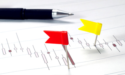 Pen on paper with flags on points.