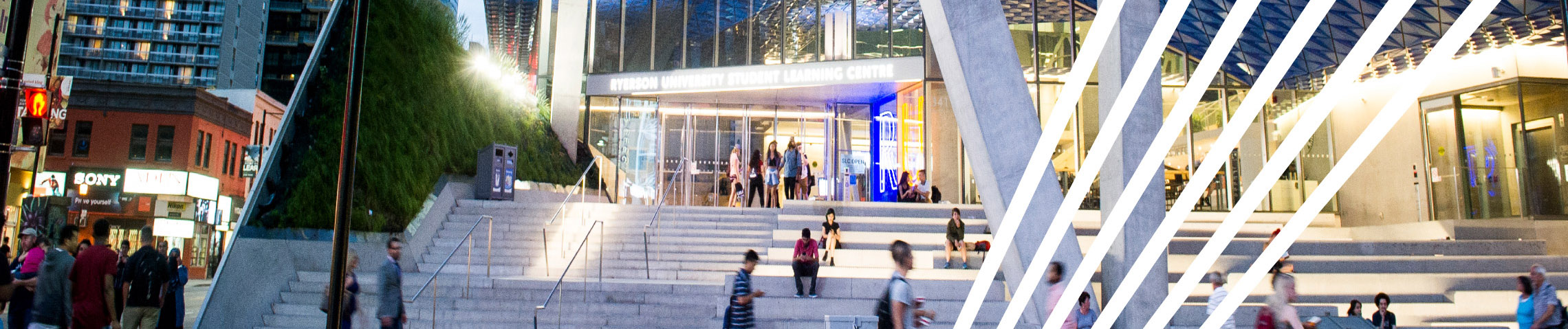 The front steps of the Student Learning Centre building at Ryerson in the evening time.