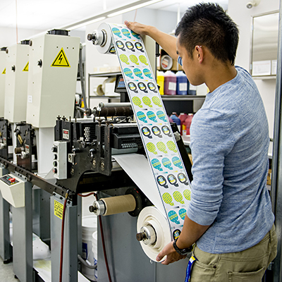 Students operating a flexography press.